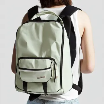 How do you properly wear a school backpack to avoid back pain?